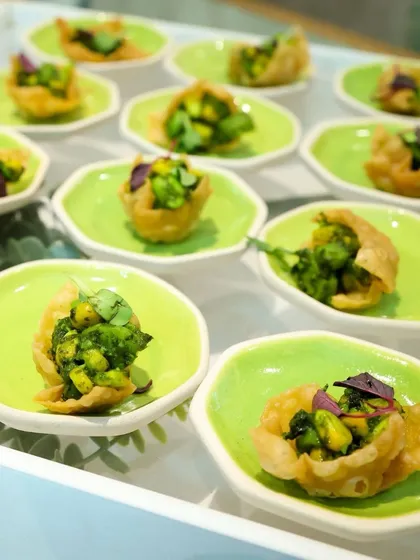 Crispy wonton cups filled with a fresh and flavourful mixture. The vibrant green plates make the presentation pop, adding a splash of colour to your event.