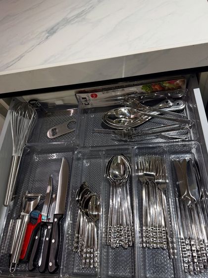 A close-up of a cutlery drawer with a tray insert. This is a simple but highly effective tool for keeping your everyday spoons, forks, and knives in order.