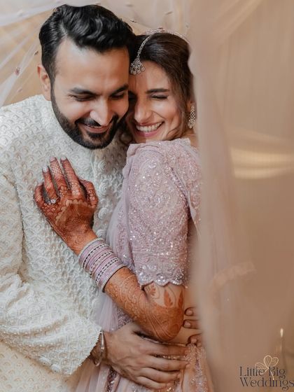 A candid, joyful hug between a couple. This black and white shot perfectly captures the raw emotion and happiness of the moment.