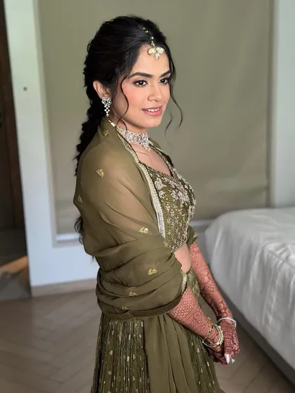 A side profile showing the soft, blended makeup and the intricate hairstyle. This is effortless elegance for a pre-wedding event.