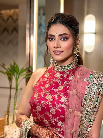 A close up showing the details of the eye makeup and the beautiful jewelry.
