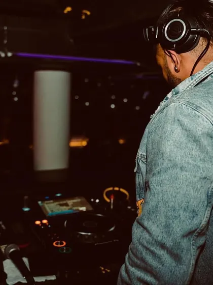 Dance with the groove. A shot from behind the decks, showing off my style. I believe a DJ's look is part of the whole performance and experience.