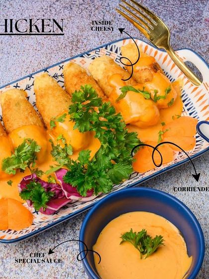 This is our Sticky Chicken, a dish that's both crunchy and cheesy. The chicken is fried to a perfect crisp and then coated in a special creamy, cheesy sauce, making it a truly indulgent starter.