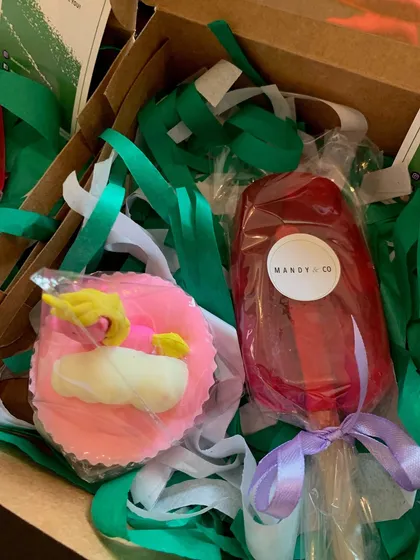 An adorable unicorn gift set featuring a pink cupcake soap with a unicorn eraser inside and a clear pink popsicle soap.