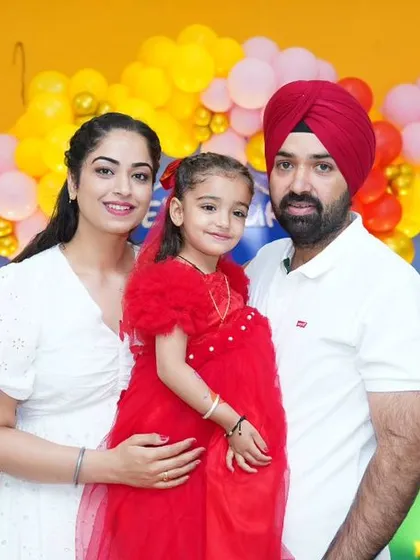 A happy family photo in front of a Peppa Pig-themed backdrop, showcasing the joy of a well-styled party.