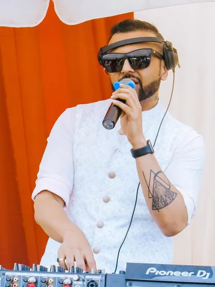 As a wedding DJ and MC, I'm right there on the mic, interacting with the guests and keeping the energy high during this beautiful outdoor Mehendi function.
