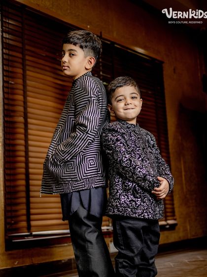 Back to back in style. This shot highlights the unique patterns of our custom bomber jackets, a perfect fusion of traditional motifs and modern silhouettes.