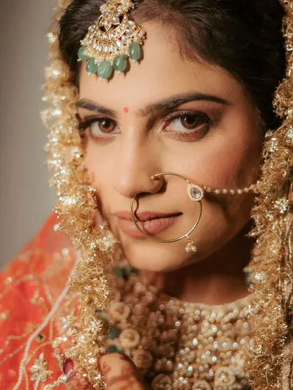 The power of a direct gaze. This intense and beautiful close-up of bride Ananya captures her confidence and the intricate details of her nath and maang tikka.