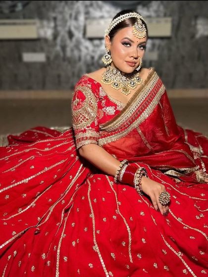A full-body shot of the red and silver lehenga, showing the beautiful contrast and intricate work.