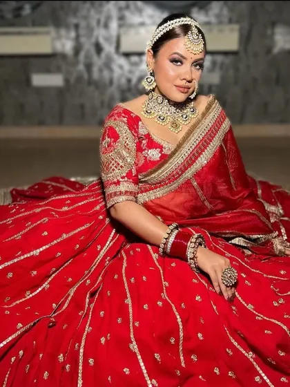 A full-body shot of the red and silver lehenga, showing the beautiful contrast and intricate work.