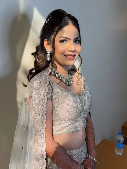 Ready for her sangeet night. The complete look, from the sparkling outfit to the glamorous hair and makeup, is pure perfection.