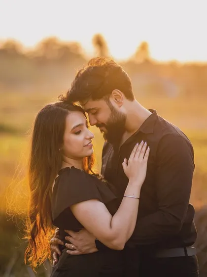 A tender forehead-to-forehead embrace at sunset. This classic romantic pose is all about shutting out the rest of the world and focusing only on each other.