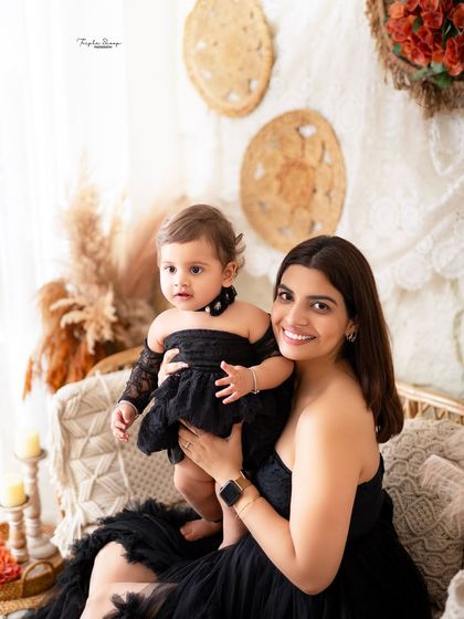 A classic mother-daughter portrait. The coordinating outfits and genuine smiles make this a photo to cherish.
