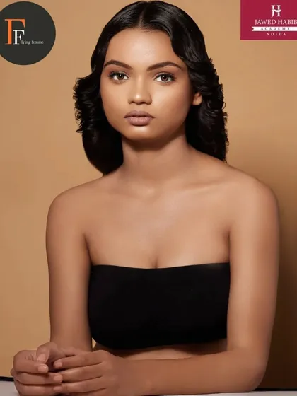A close up of the model's face, highlighting the flawless skin and subtle makeup.