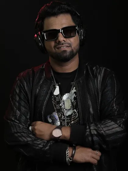 A professional portrait that captures my focus and style. As a DJ, my image and stage presence are part of the package, ensuring a confident and stylish vibe that matches the music.