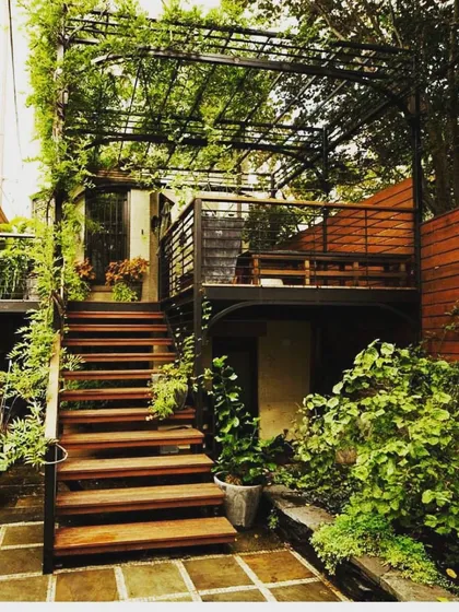 Even a compact urban plot can become a tropical paradise. We designed this multi-level deck and pergola system to maximize vertical space, using climbing plants and lush foliage to create a private, green escape in the city.