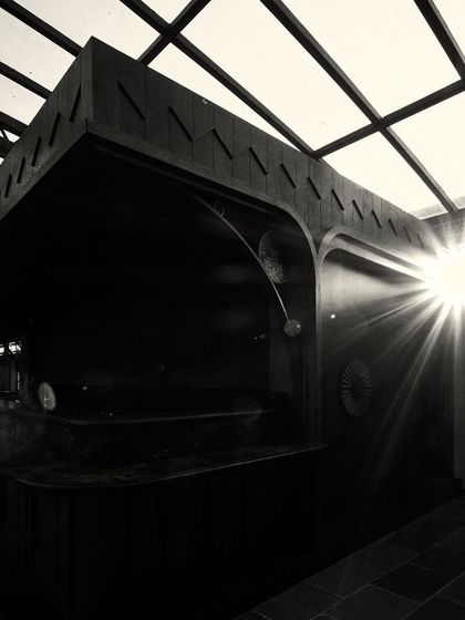 A sunburst effect as light streams into the dark, wood-paneled bar area, creating a moment of high drama.