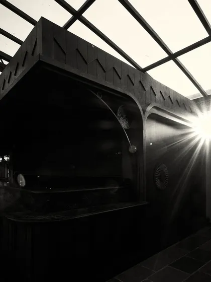 A sunburst effect as light streams into the dark, wood-paneled bar area, creating a moment of high drama.