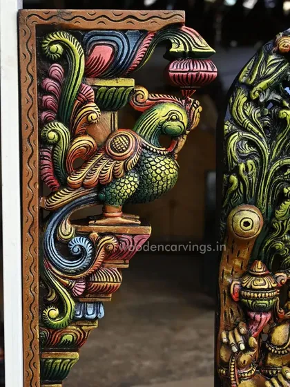 Another view of the Annapakshi bracket next to the Ganesha statue, showing how the color palettes of the two pieces are designed to complement each other.