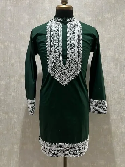 A dark green kurta with intricate white embroidery, a classic combination for any festive occasion.