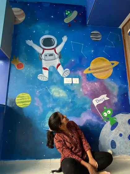 Creating magical spaces for kids is so much fun. This space-themed mural features a happy astronaut, planets, constellations, and even a friendly alien holding a custom name flag, turning a simple room into a galaxy of adventures.