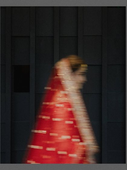 An artistic motion-blur shot of the bride in her red lehenga. This abstract image captures the feeling and movement of the day, turning a fleeting moment into a piece of art.
