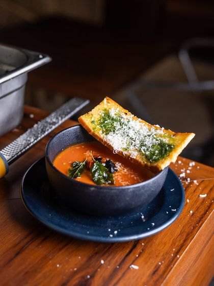 The day can wait while you sink into our bowl of Roasted Tomato Soup. Paired with a Parmesan and Pesto Crostini, each spoonful feels like wrapping yourself in a blanket of flavours.