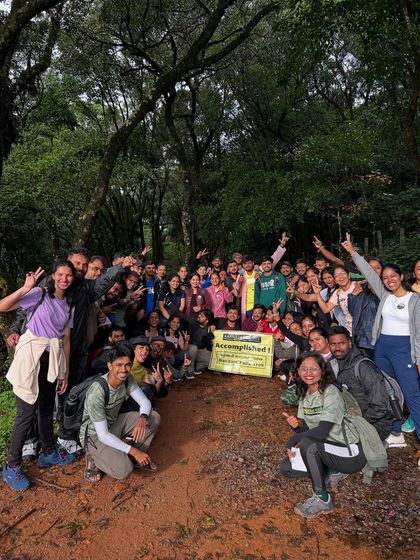A big, happy group photo in the forest, celebrating the completion of the Bandaje trek.