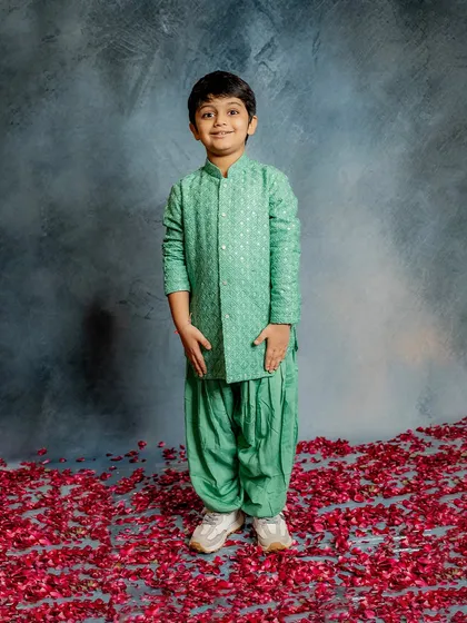 A full-length view of our happy model in the mint green Patiala set. The comfortable fit and soft fabric are perfect for a day full of celebration and play.