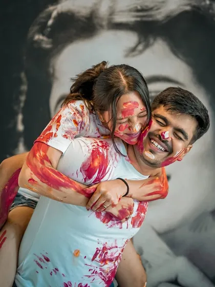 A playful piggyback ride during a fun, color-filled Holi-themed pre-wedding shoot. We love capturing your most joyful moments.
