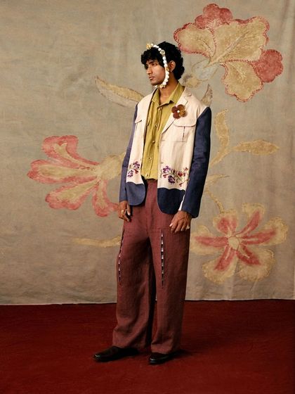 A full-look from Cord's "Vinyl Echoes" menswear collection, shot against a custom painted floral backdrop.