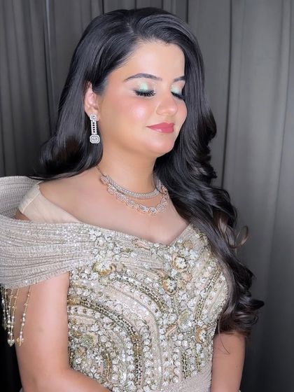 Another angle of this boundlessly beautiful Sangeet look. The soft pink blush and glossy lips perfectly complement the subtle green and silver tones on the eyes.