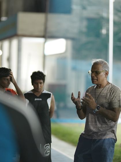 An experienced coach sharing his wisdom with our players during a basketball skills workshop. These moments of mentorship are invaluable.