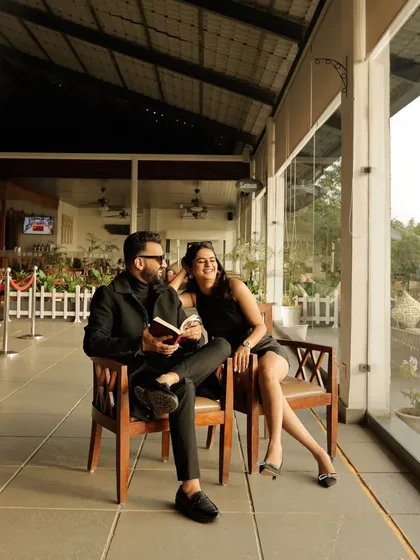 A relaxed moment of the couple reading a book together. This lifestyle shot captures a quiet, everyday intimacy that is both sweet and stylish.