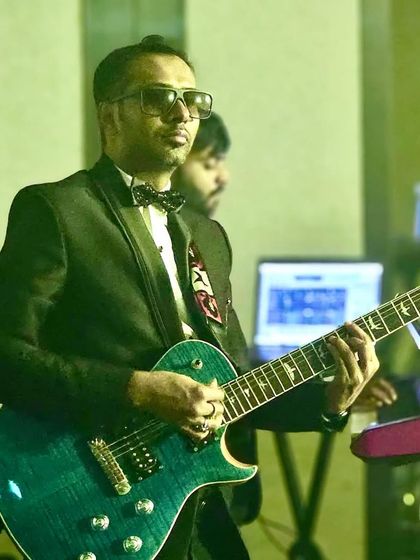 Our lead guitarist in action, playing a solo during the corporate gig at JW Marriott.