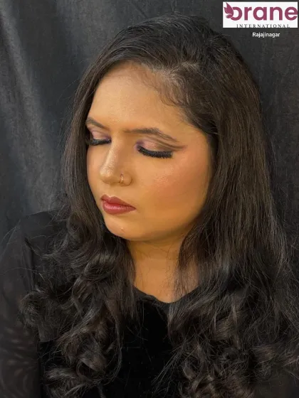 A close-up with eyes closed to show the subtle purple tones in the eyeshadow.
