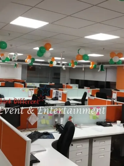 Here's how I decorate a large open-plan office with cubicles. Tricolor balloon clusters are hung from the ceiling to ensure the festive spirit is visible from every desk.