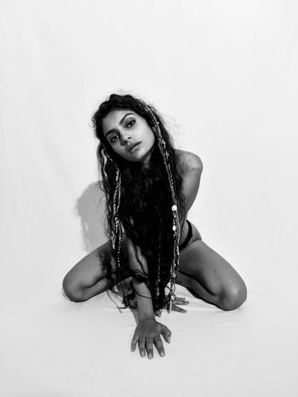 A seated pose that is both powerful and introspective. The monochrome treatment gives it a timeless quality.