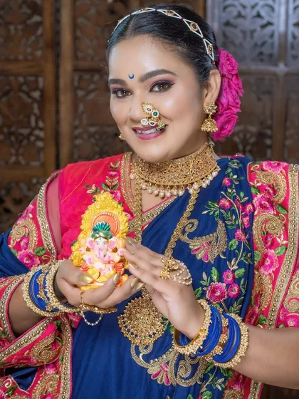 Celebrating Ganesh Chaturthi with a traditional look, holding a small Ganpati idol. A moment of devotion and beauty.