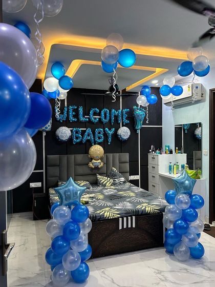 Another perspective of the blue and white 'Welcome Baby' room setup.