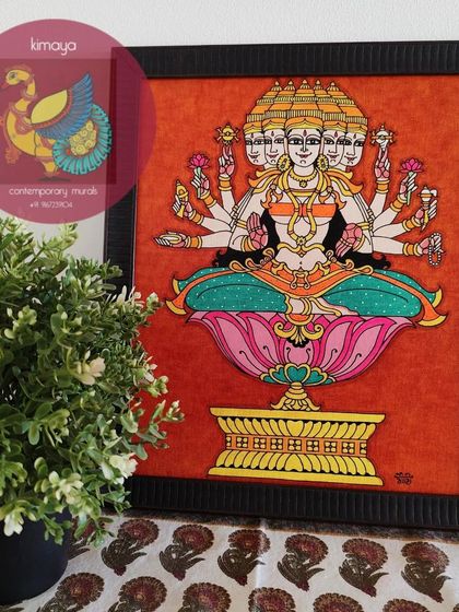 This is my depiction of Gayatri Devi, the mother of the Vedas, with her five heads and ten arms. This 12x14 inch framed painting, set against a rich orange background, is a powerful symbol of spiritual knowledge and light.