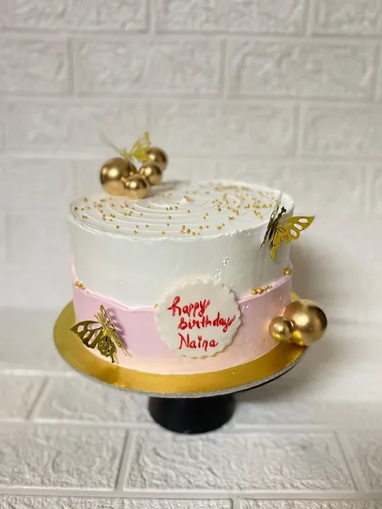 The secret ingredient is always love, and sometimes sprinkles. A simple and elegant butterscotch cake with pink, white, and gold details.