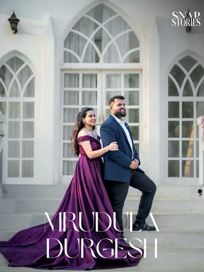 A stylish couple portrait on the steps of a beautiful white villa. This image is part of a series that captures a sophisticated and modern pre-wedding story.