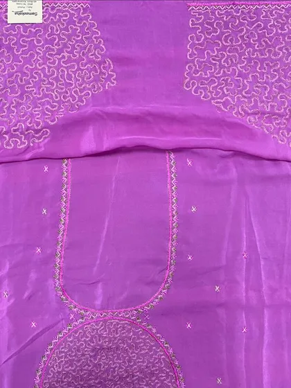 A beautiful lavender blouse piece with intricate threadwork outlining the neckline and forming large motifs on the sleeves. This is ready to be tailored into a custom blouse.