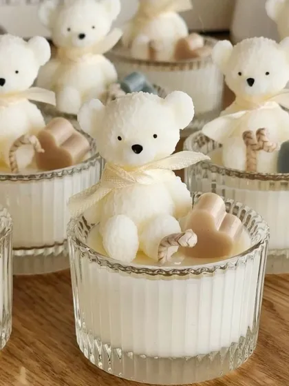 Another take on our baby announcement gifts. These sweet white teddy bear candles in crystal jars are a classic and elegant way to celebrate the arrival of your little one.