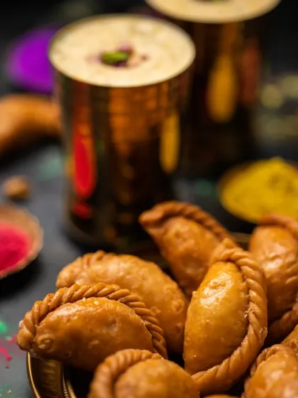 Another angle of the Gujjiya and Thandai, this time in brass glasses. I experiment with different props to create various looks for the same product.