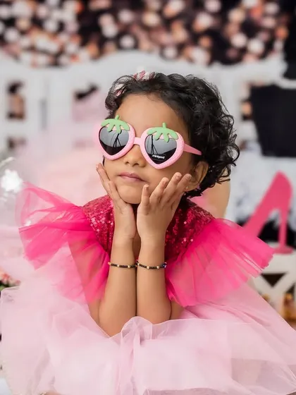 A sassy and fun pose from the older sister during their Barbie-themed sibling photoshoot.