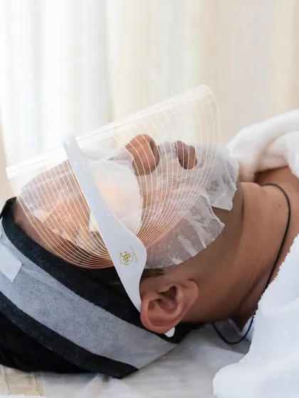 The HydraPro facial is a client favorite for achieving a "glow bomb" effect. Here, an LED therapy mask is used as part of the treatment to further enhance skin rejuvenation.