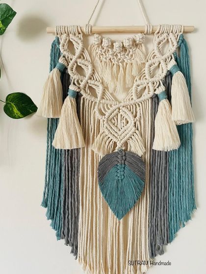 A full look at the 'Bella' tapestry. The combination of colors and textures with the tassels and leaf makes it a really unique piece of wall art.