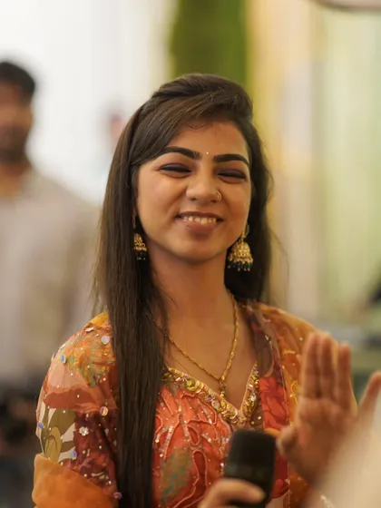 A close-up candid, smiling at a guest. These small, happy moments make every event special.